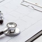 new stethoscope on a white background with cardiogram isolated